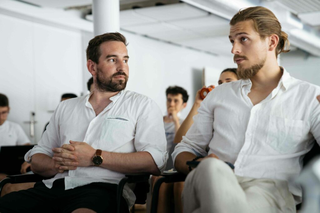 Andrew Zappella, CTO at Audacia, and Victor Lequet, Head of Ventures, are listening to presentations of student's projects at the HESSO Sierre.